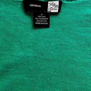 Green cardigan open front with laces, sleeves elbows length.